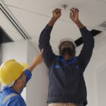 Engineers,Team,Installing,Fire,Sprinkler,In,Office,At,Building,Site,